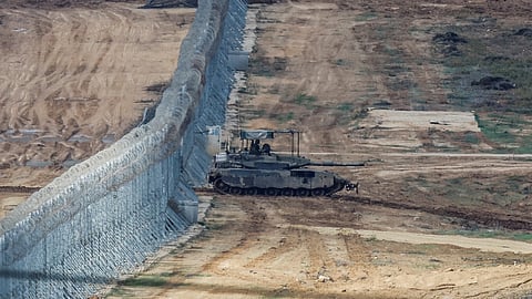 An Israeli Merkava tank manoeuvres near the Israel-Gaza border, amid the temporary truce between Hamas and Israel, as seen from southern Israel, November 28, 2023. 