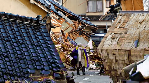 A woman, whose house was damaged by an earthquake carries her belongings as she heads to an evacuation centre, in Wajima, Ishikawa Prefecture, Japan, January 5, 2024. 
