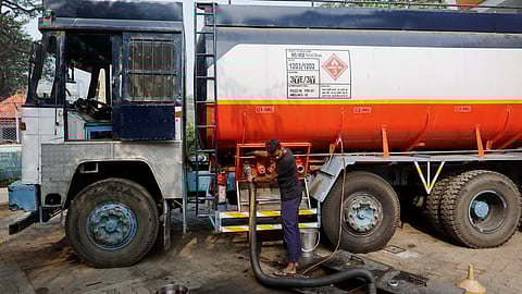 A man opens a valve of a fuel tanker during the refilling of an underground fuel tank, after a petrol pump ran out of fuel after shortages following a nationwide strike by truckers, which was called off on Tuesday night after talks with the government and demanded revocation of a newly enacted law imposing penalties for hit-and-run accidents, at a petrol pump in Mumbai, India, January 3, 2024. 
