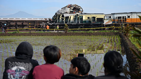 Locals watch the site of a train collision between the local Bandung Raya train and the Turangga train in Cicalengka, Bandung, West Java province, Indonesia, January 5, 2024, in this photo taken by Antara Foto. 
