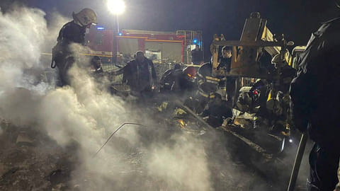 Rescues work at a site of a residential building damaged during a Russian drone strike, amid Russia's attack on Ukraine, in Vinnytsia region, Ukraine, in this handout photo released March 15, 2024.
