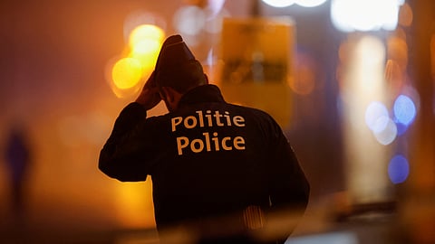FILE PHOTO: A Belgian police officer stands guard outside the area where, according to police, a shooting took place, injuring several police officers, in Brussels, Belgium, December 6, 2023. 