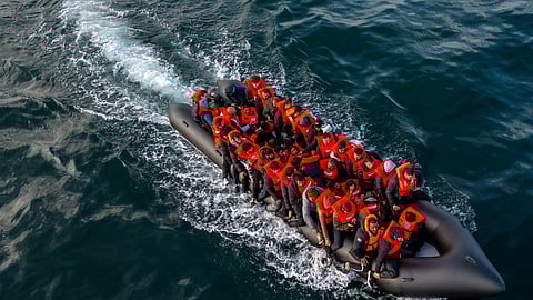 In this drone view an inflatable dinghy carrying migrants makes its way towards England in the English Channel, Britain, May 4, 2024. 
