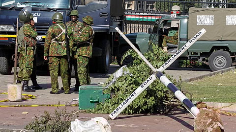 Police officers stand outside the Parliament building where protesters who are against the Kenya's proposed finance bill 2024/2025 were shot dead in Nairobi, Kenya, June 26, 2024. 