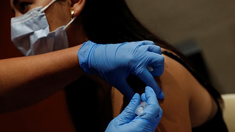 FILE PHOTO: A nurse applies a dose of COVID-19 vaccine in Sarasota, Florida, U.S., September 24, 2021. 