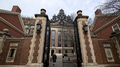 FILE PHOTO: A person walks through Harvard yard at Harvard University in Cambridge, Massachusetts, U.S., December 7, 2023. 