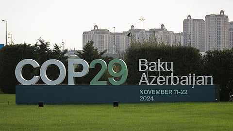 FILE PHOTO: A view shows a sign of the COP29 United Nations Climate Change Conference with a backdrop of the cityscape in Baku, Azerbaijan October 31, 2024. 