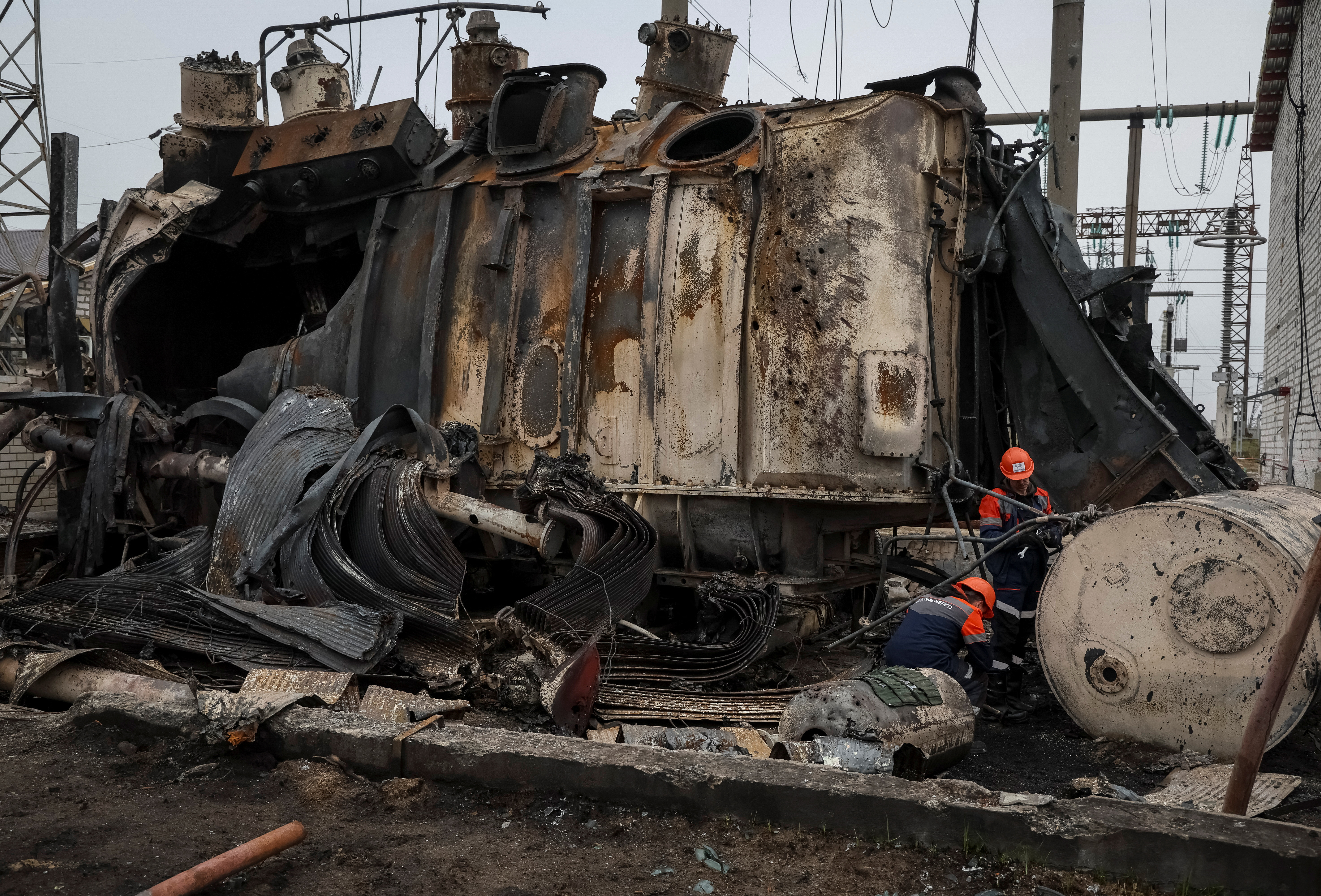 Employees work at a compound of a high-voltage substation of Ukrenergo damaged by Russian military strike, amid Russia's attack on Ukraine, in an undisclosed location in central Ukraine November 10, 2022. 
