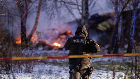A Police officer guards the DHL cargo plane crash site near Vilnius International Airport, Lithuania November 25, 2024.