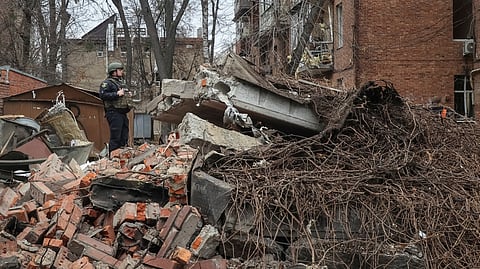 A police officer stands at a site of apartment buildings hit by a Russian missile strike, amid Russia's attack on Ukraine, in Kharkiv, Ukraine November 25, 2024. 