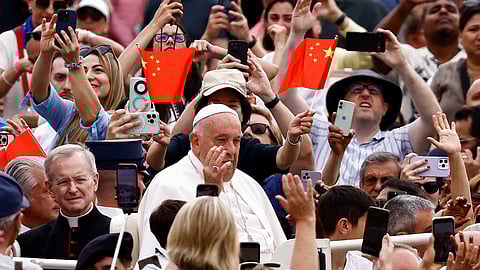 FILE PHOTO: Pope Francis arrives for the weekly general audience as people wave Chinese flags at Saint Peter's Square at the Vatican, June 19, 2024. 