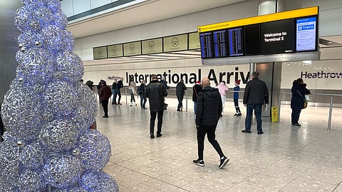 People wait in the arrivals hall at terminal 5 of Heathrow Airport, near London, Britain, December 23, 2022. 