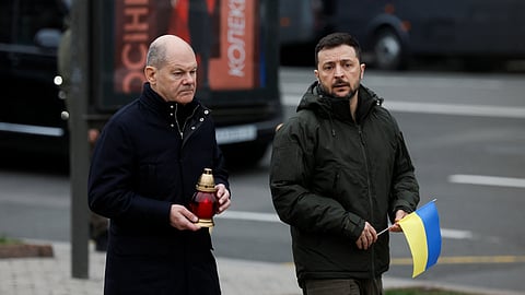 Ukraine's President Volodymyr Zelenskiy and German Chancellor Olaf Scholz walk to visit a makeshift memorial place displaying Ukrainian flags with the names of fallen service members, at the Independence Square, amid Russia's attack on Ukraine, in Kyiv, Ukraine December 2, 2024. 