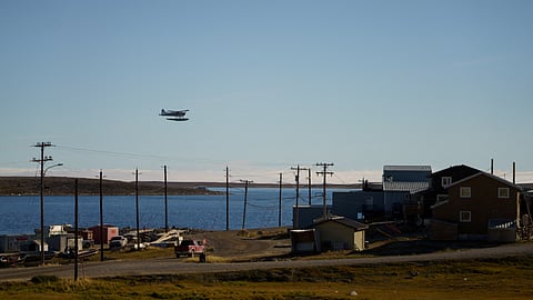 FILE PHOTO: A float plane flies past the Arctic community of Cambridge Bay, Nunavut, Canada August 25, 2022. 