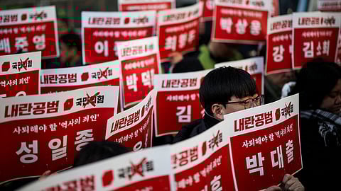 Protesters hold signs, depicting the names of ruling People Power Party lawmakers who didn't vote during the impeachment motion against South Korean President Yoon Suk Yeol last Saturday, as they attend a rally calling for the impeachment of President Yoon Suk Yeol, who declared martial law, which was reversed hours later, in front of the headquarters of the ruling People Power Party in Seoul, South Korea, December 9, 2024. 