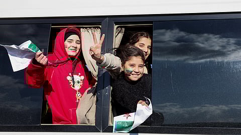 Syrians gesture from a bus as they are heading to Syria, after Syrian rebels announced that they have ousted President Bashar al-Assad, at Majdal Anjar in Bekaa, Lebanon, December 8, 2024.