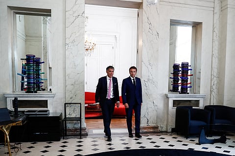 French President Emmanuel Macron walks next to First Secretary of the Socialist Party (PS) Olivier Faure after their meeting at the Elysee Palace in Paris, France, June 21, 2022.