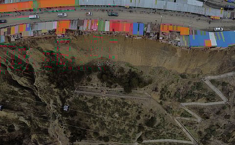 FILE PHOTO: A drone view shows a row of houses, locally known as 'suicide homes', dwellings built on the edge of an earth cliff and often serving as workplaces for Aymara shamans, in El Alto, Bolivia December 3, 2024. 