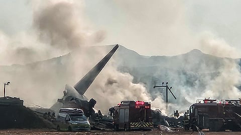 Firefighters carry out extinguishing operations on an aircraft which drove off runaway at Muan International Airport in Muan, South Jeolla Province, South Korea, December 29, 2024. 