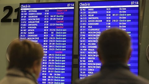 FILE PHOTO: People look at an information board at Pulkovo airport outside St. Petersburg, Russia, November 7, 2015. 