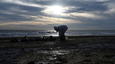 FILE PHOTO: A volunteer works to clear spilled oil on the coastline following an incident involving two tankers damaged in a storm in the Kerch Strait, in the settlement of Blagoveshchenskaya near the Black Sea resort of Anapa in the Krasnodar region, Russia December 21, 2024.