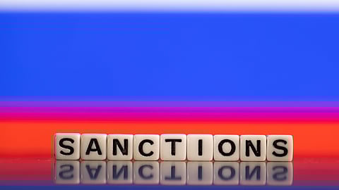 FILE PHOTO: Plastic letters arranged to read "Sanctions" are placed in front of Russian flag colors in this illustration taken February 25, 2022. 