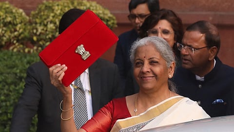 India's Finance Minister Nirmala Sitharaman holds up a folder with the Government of India's logo as she leaves her office to present the annual budget in the parliament, in New Delhi, India, February 1, 2025. 