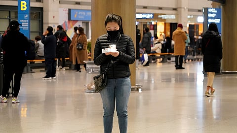 FILE PHOTO: A woman checks her ticket on her cellphone at Incheon International Airport in Incheon, South Korea, January 3, 2020. 
