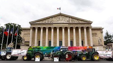 Tractors are parked in front of the French parliament, the Assemblee Nationale, as French farmers gather for a protest to call on lawmakers to adopt a bill that would loosen restrictions on pesticide and water use in farming, in Paris, France May 26, 2025. 