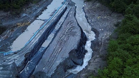 The swollen Corund river spills down inside the Praid Salt Mine following increased levels due to floods, in Harghita, Romania, May 28, 2025. 