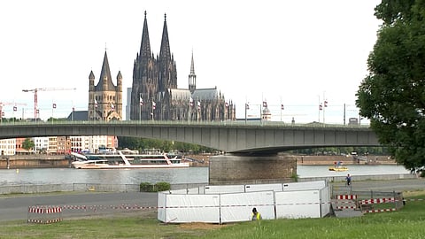 A person works by a cordoned off area near the Cologne Cathedral, after the discovery of World War II-era bombs during exploratory work, affecting over 20,000 people, who had to be evacuated on June 4, 2025, in Cologne, Germany, in this still image from undated video. 
