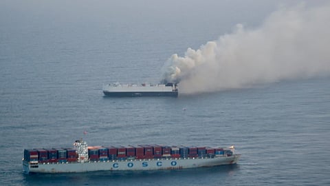 Smoke rises from a fire aboard the cargo vessel Morning Midas, carrying around 3,000 vehicles, including 800 electric vehicles, as seen in an aerial photograph taken from a U.S. Coast Guard C-130J Super Hercules, approximately 300 miles south of Adak, Alaska, U.S. June 3, 2025.