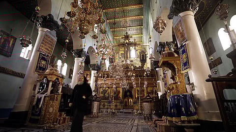 FILE PHOTO: A monk walks inside the basilica of St. Catherine's Monastery in South Sinai, Egypt, March 7, 2019. Picture taken March 7, 2019. 

