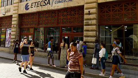 FILE PHOTO: People pass by an office of state-run telecommunications company ETECSA in Havana, Cuba June 3, 2025. 