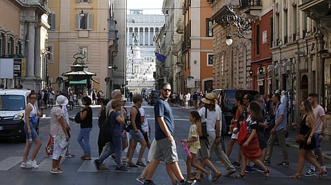 FILE PHOTO: People cross the street in Rome Italy, August 29, 2019. 