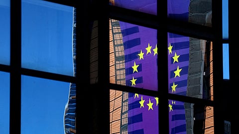 FILE PHOTO: A banner depicting an European Union flag is reflected in a window outside the EU Council headquarters in Brussels, Belgium March 18, 2025. 