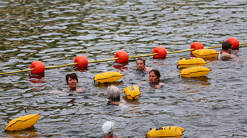 People swim in the River Seine at the Bras Marie site, opened to swimmers marking the first public bathing session in the capital's historic waterway, in Paris, France, July 5, 2025. 