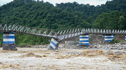 The collapsed Dudhia Iron Bridge over the Balason River after torrential rains in Darjeeling, India, October 5, 2025. 