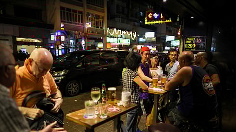 FILE PHOTO: People have a drink inside a bar in Hong Kong, China October 25, 2019. 