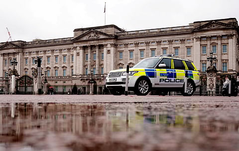 A police vehicle drives past Buckingham Palace in London, Britain, January 4, 2022. 