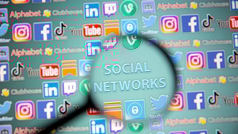 Social network words and social media logos are seen through magnifier displayed in this illustration taken, May 25, 2021. Picture taken May 25, 2021. 