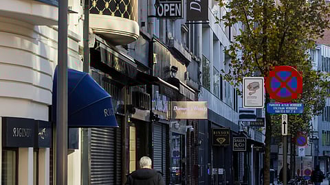 A man walks past diamond shops in the city centre of Antwerp, Belgium November 7, 2025.
