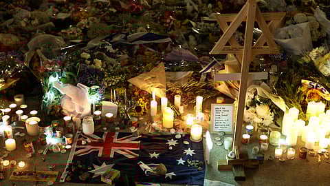 FILE PHOTO: An Australian flag sits amongst floral tributes honouring the victims of a shooting at Jewish holiday celebration on Sunday at Bondi Beach, in Sydney, Australia, December 16, 2025.