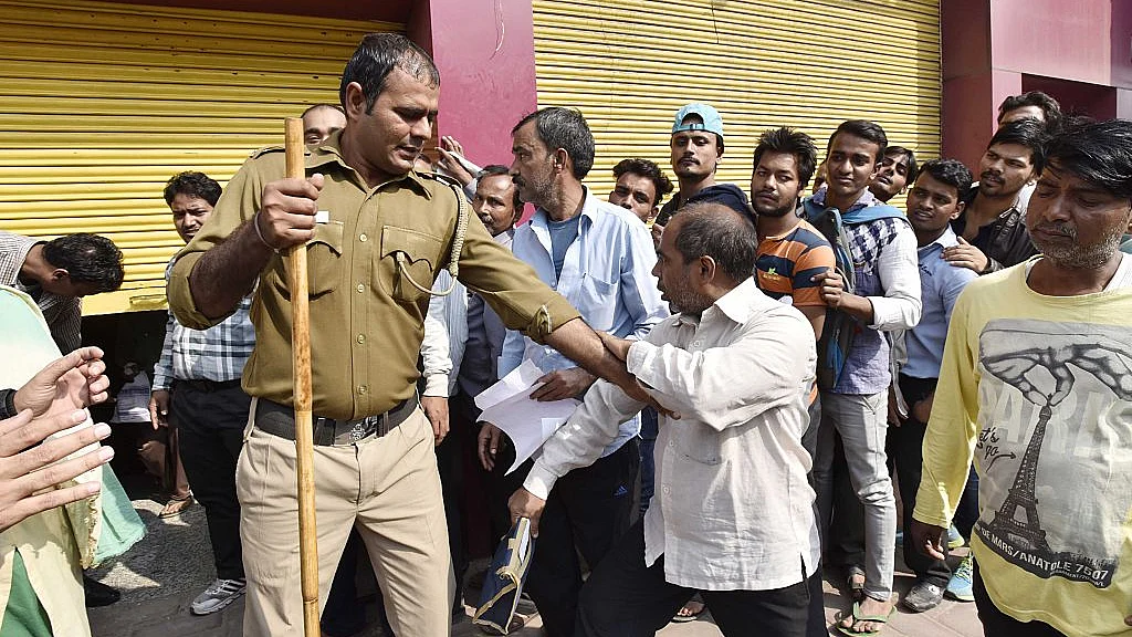 

 Policing a queue outside a bank, after the government demonetised Rs 500 and 1,000 currency notes, in New Delhi, on November 16, 2016