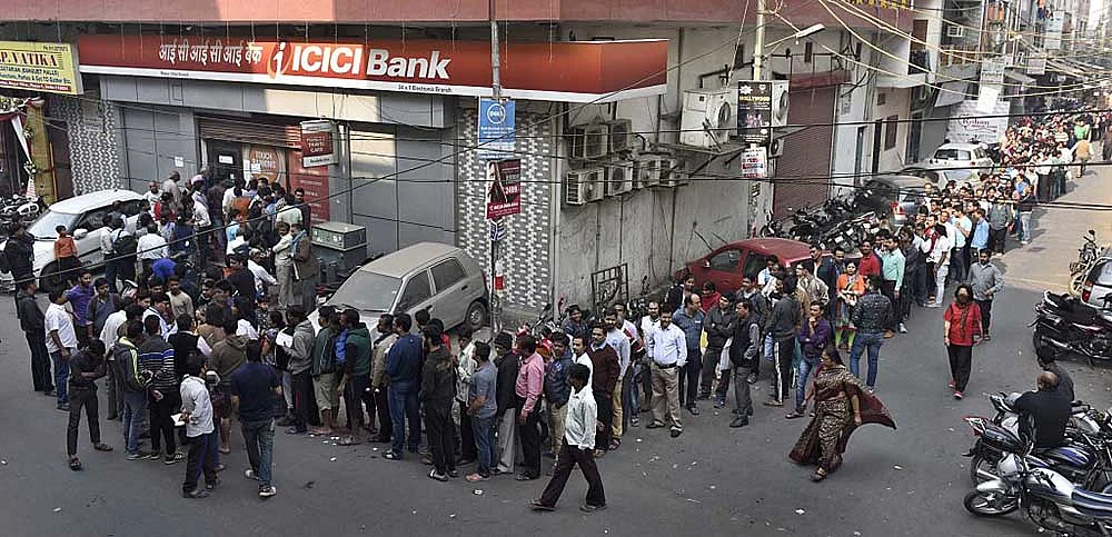Tempers began fraying as thousands queued for hours outside banks to swap demonetised 500 and 1,000 rupee notes; Photo by Sushil Kumar/Hindustan Times via Getty Images
