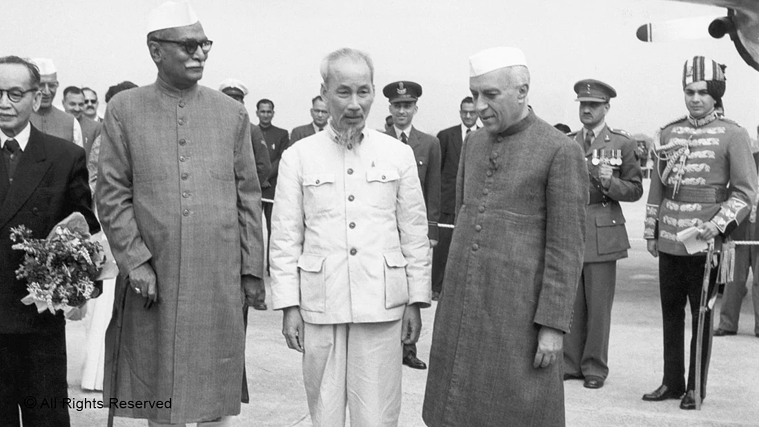 LOOKING EAST—President Rajendra Prasad (left) and Prime Minister Jawaharlal Nehru (right) greet North Vietnamese President Ho Chi Minh on his arrival at New Delhi’s Palam Airport in 1958.