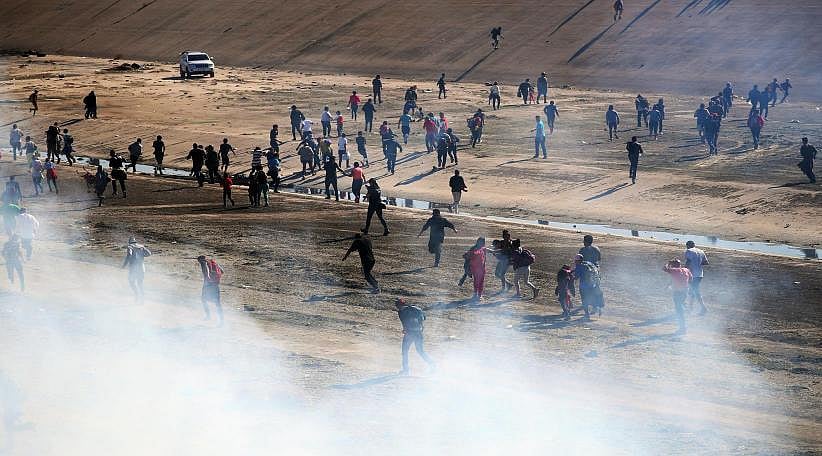 US border agents fire tear gas at migrants to deter breach of US-Mexico border fence