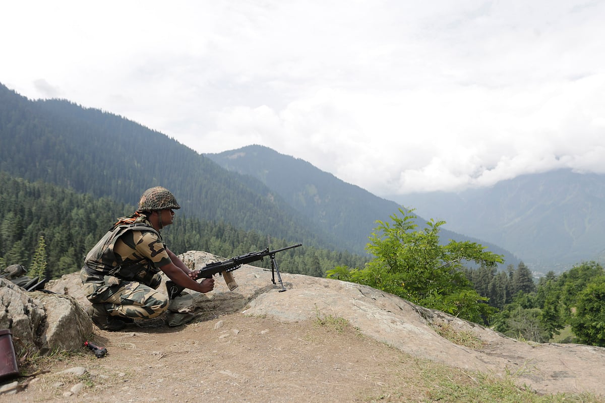 A Border Security Force soldier stands guard on a mountain on July 11, 2017 in Chandanwari, around 116 kilometers south of Srinagar in Jammu and Kashmir.