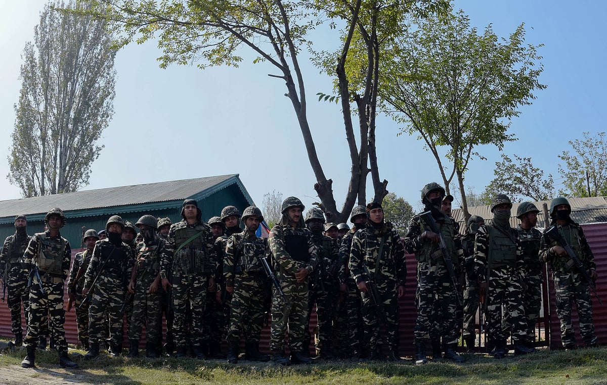 Paramilitary troopers of Sashastra Seema Bal or the Armed Border Force look towards the coffin containing the body of their comrade killed in a militant attack, during his wreath laying ceremony on October 15, 2016 in Srinagar, Jammu and Kashmir.