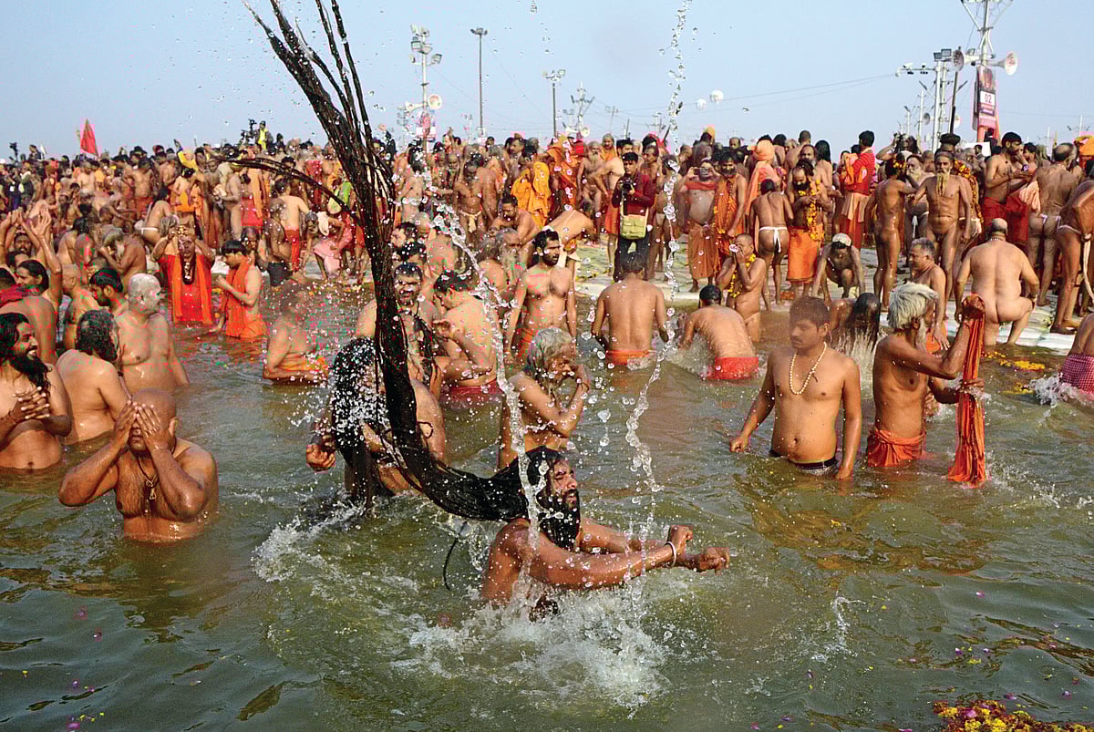 Indian naked sadhus jump into the waters of the holy Sangam during the auspicious bathing day of ‘Mauni Amavasya’ at the Kumbh Mela in Allahabad on February 4, 2019 